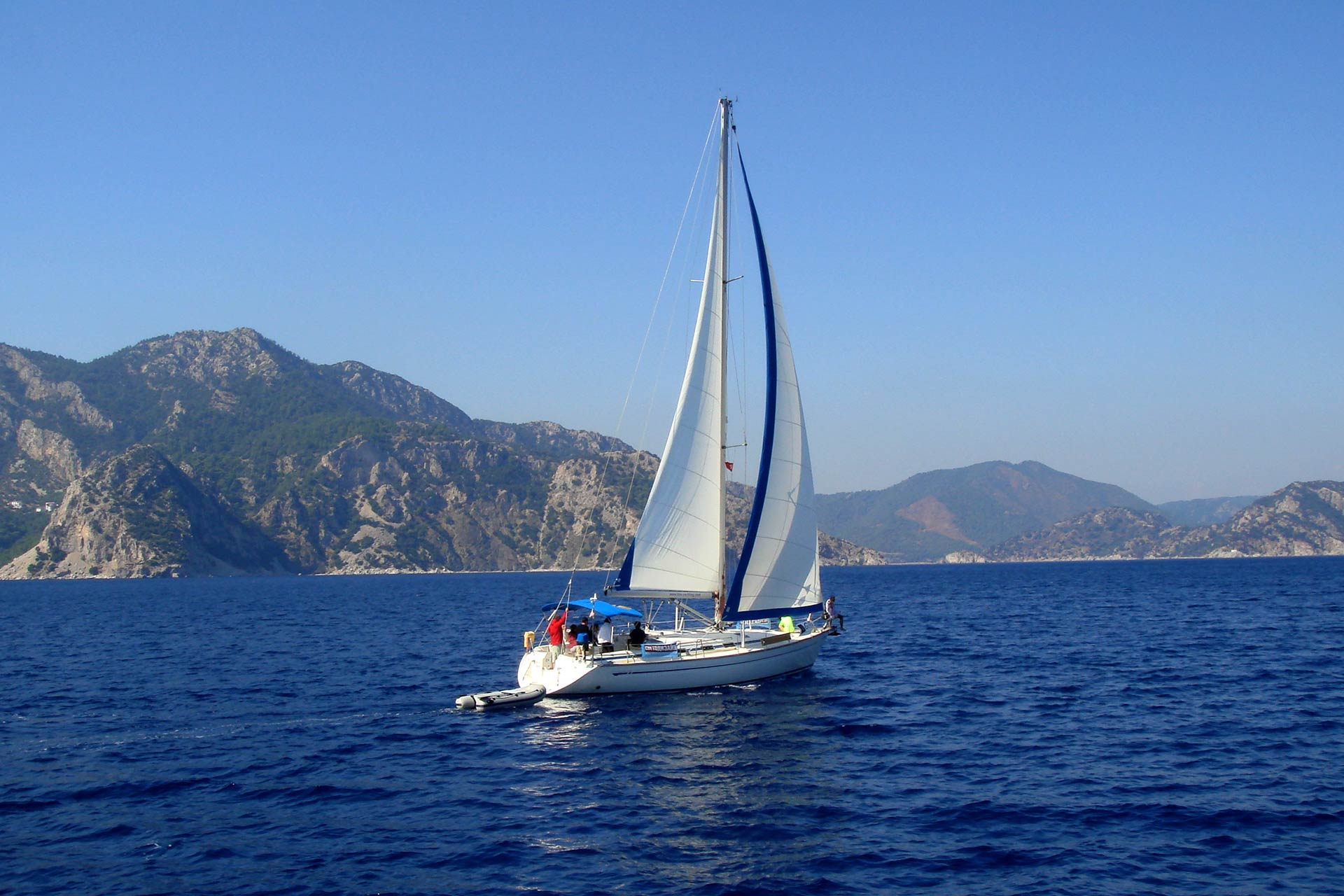 yacht-with-white-sail-sailing-on-a-calm-sea-on-a-b-2022-05-11-22-46-02-utc.jpg